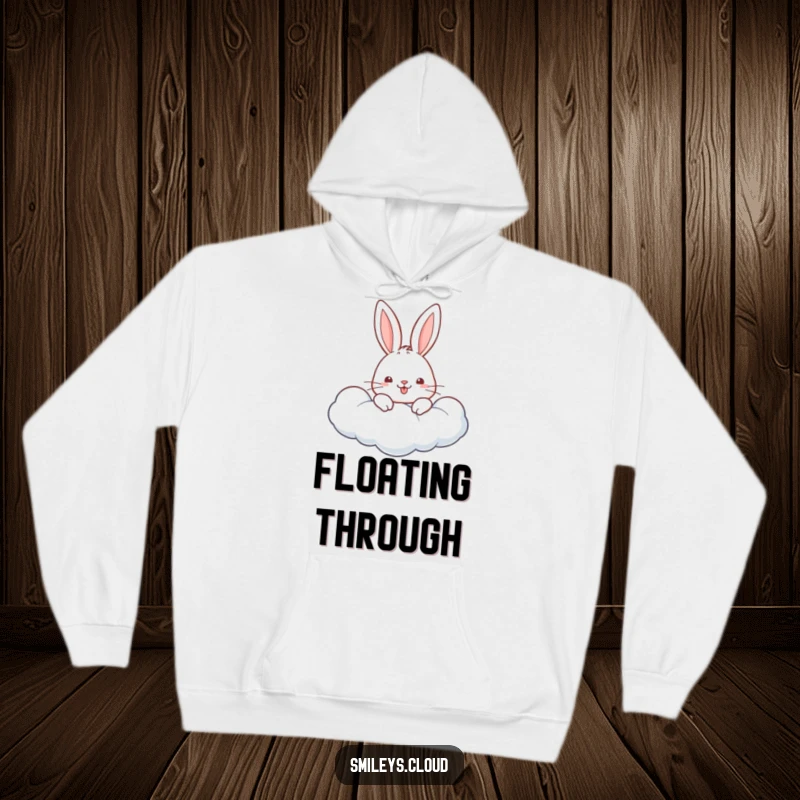 Funny hoodie featuring a cheerful rabbit peeking from a soft, fluffy cloud, exuding happiness and warmth.