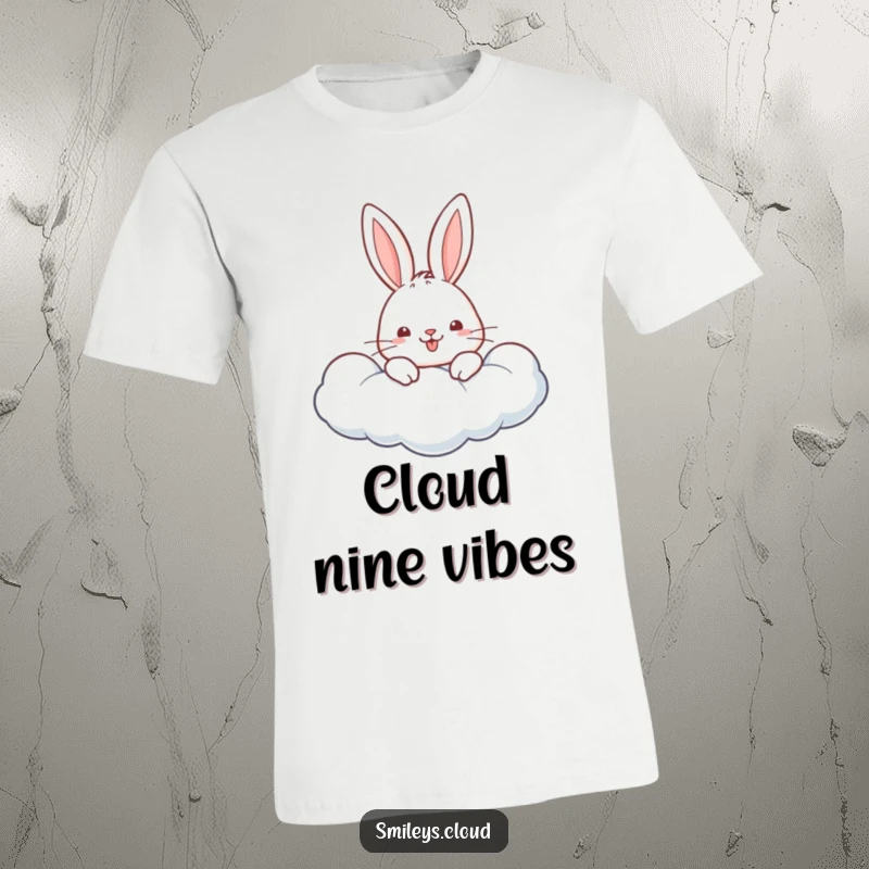 Funny t-shirt graphic of a happy rabbit peeking over the edge of a fluffy, white cloud, looking playful.